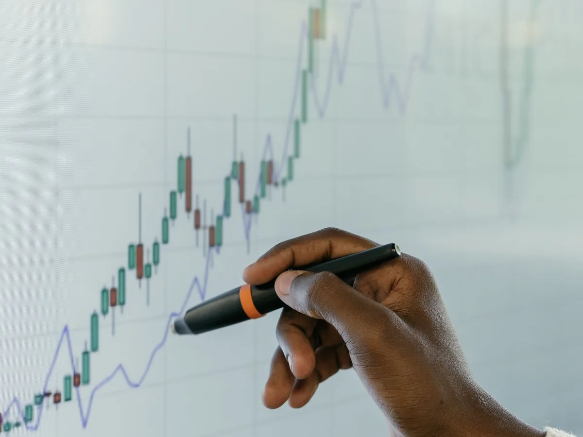 A hand drawing a rising growth chart