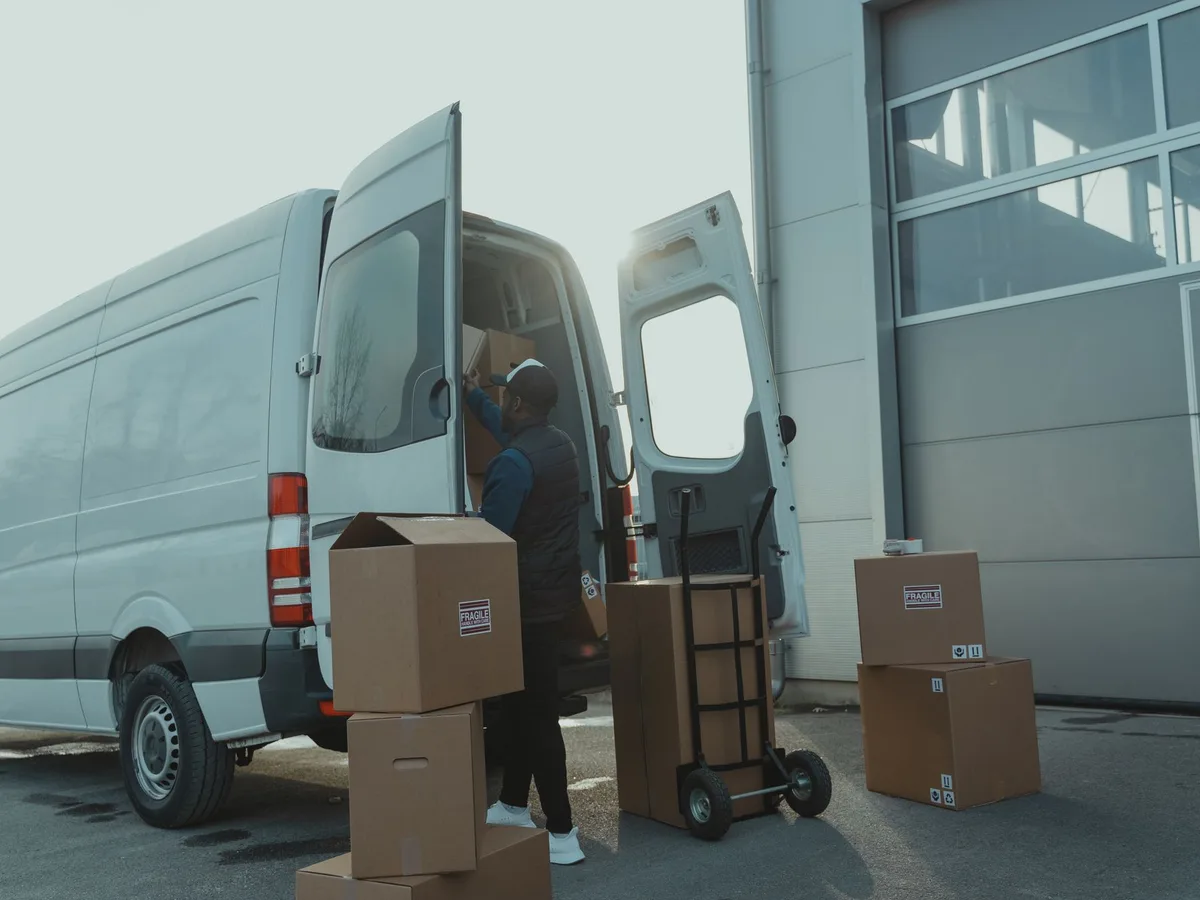 Boxes being loaded into a delivery van at a warehouse